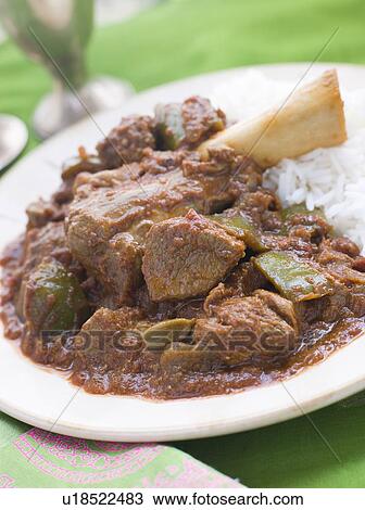 Stock Image - Lamb Shank Rogan Josh Gosht with Plain Basmati Rice. Fotosearch