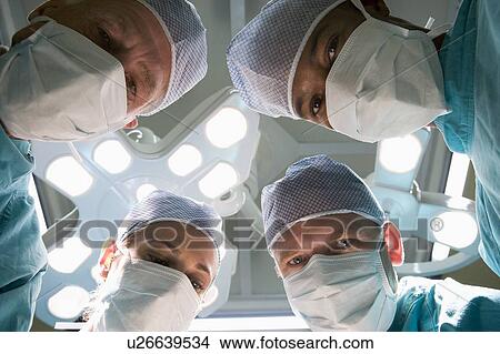 Picture - Low Angle View Of Four Surgeons. Fotosearch