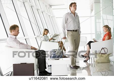 Male airline passenger waiting with other passengers in departure gate View Large Photo Image Stock Image - Male airline passenger waiting with other passengers in departure gate. Fotosearch