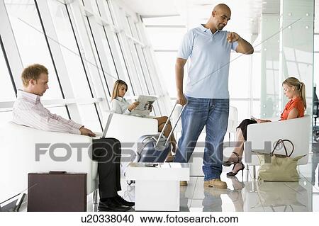 Male airline passenger waiting with other passengers in departure gate View Large Photo Image Stock Image - Male airline passenger waiting with other passengers in departure gate. Fotosearch