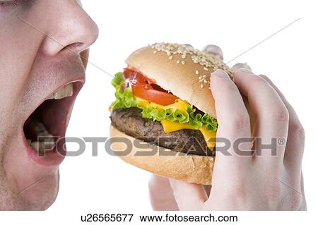 Stock Photo - Man About To Bite Into A Cheeseburger. Fotosearch