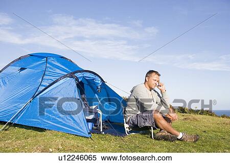 Stock Photography - Man camping outdoors. Fotosearch