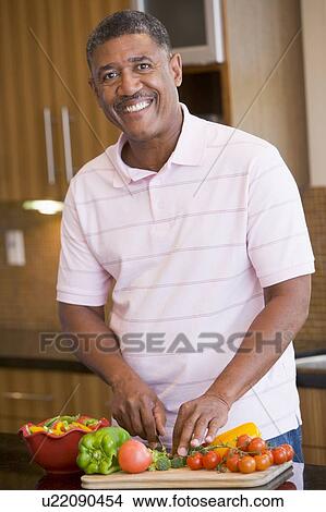 Picture - Man Chopping Vegetables. Fotosearch