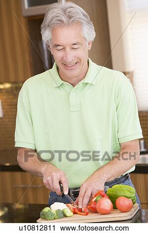 Stock Image - Man Chopping Vegetables. Fotosearch
