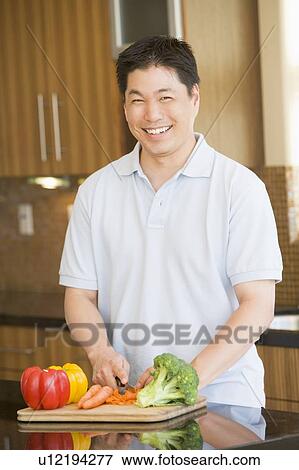 Man Chopping Vegetables View Large Photo Image Stock Photo - Man Chopping Vegetables. Fotosearch