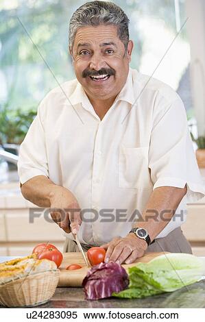 Stock Photography - Man Chopping Vegetables. Fotosearch