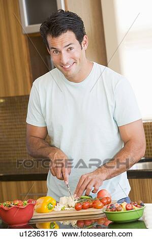 Stock Photograph - Man Cutting Vegetables. Fotosearch