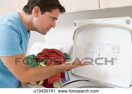 Stock Image - Man Doing Laundry. Fotosearch