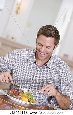 Man Eating Healthy meal, mealtime Together View Large Photo Image Stock Image - Man Eating Healthy meal, mealtime Together. Fotosearch