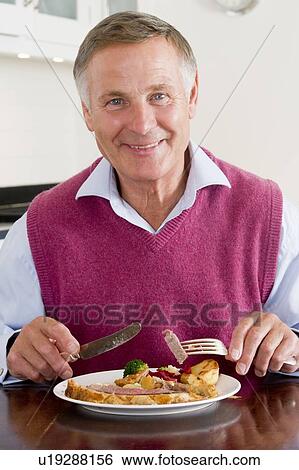 Man Enjoying Healthy meal, mealtime View Large Photo Image Stock Photograph - Man Enjoying Healthy meal, mealtime. Fotosearch