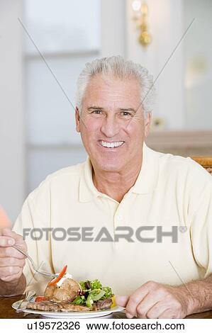 Man Enjoying Healthy meal, mealtime View Large Photo Image Stock Photograph - Man Enjoying Healthy meal, mealtime. Fotosearch