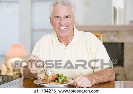 Man Enjoying Healthy meal, mealtime View Large Photo Image Stock Photography - Man Enjoying Healthy meal, mealtime. Fotosearch