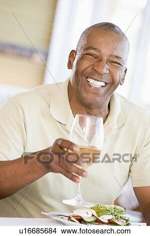 Man Enjoying meal, mealtime With A Glass Of Wine View Large Photo Image Picture - Man Enjoying meal, mealtime With A Glass Of Wine . Fotosearch