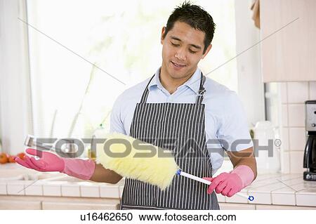 Man Holding Duster And Wearing Rubber Gloves View Large Photo Image Stock Image - Man Holding Duster And Wearing Rubber Gloves. Fotosearch