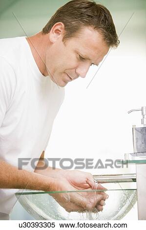 Man in bathroom washing hands View Large Photo Image Stock Photography - Man in bathroom washing hands. Fotosearch