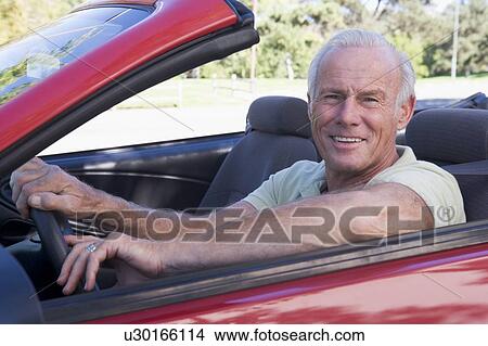 Man in convertible car smiling View Large Photo Image Picture - Man in convertible car smiling. Fotosearch