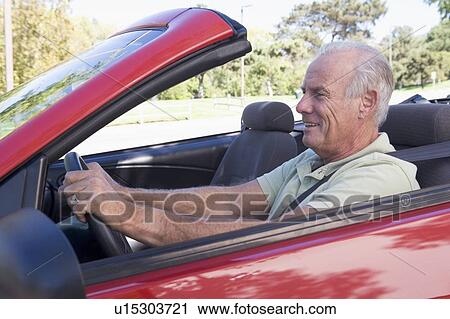 Man in convertible car smiling View Large Photo Image Stock Image - Man in convertible car smiling. Fotosearch