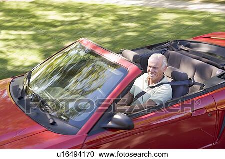 Man in convertible car smiling View Large Photo Image Stock Image - Man in convertible car smiling. Fotosearch