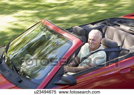 Man in convertible car smiling View Large Photo Image Stock Photography - Man in convertible car smiling. Fotosearch