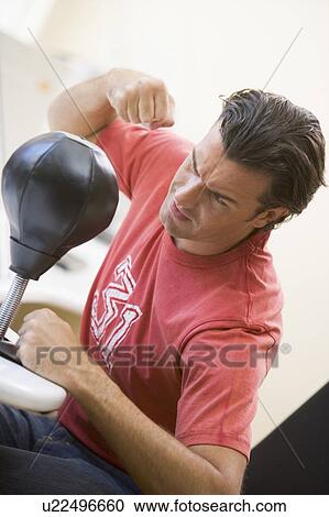 Man indoors using small punching bag View Large Photo Image Stock Image - Man indoors using small punching bag. Fotosearch