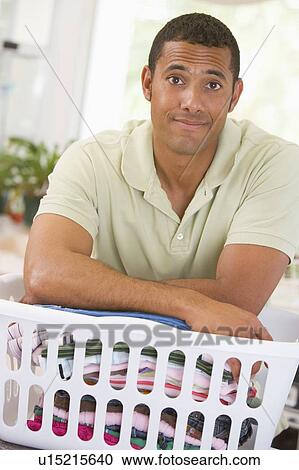 Stock Image - Man Leaning On Laundry . Fotosearch