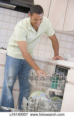 Stock Photo - Man Loading Dishwasher . Fotosearch