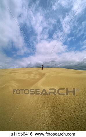 Stock Photograph - Man outdoors in desert running (far away). Fotosearch