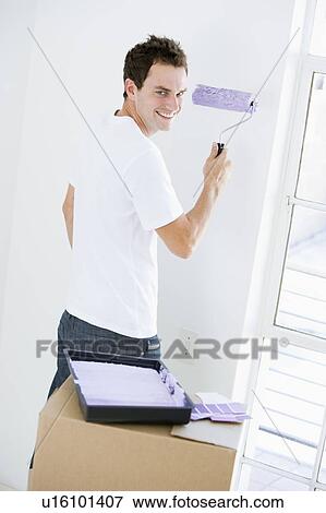 Man painting room in new home smiling View Large Photo Image Stock Photo - Man painting room in new home smiling. Fotosearch