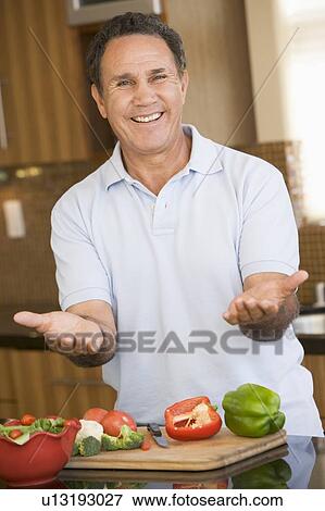 Man Preparing meal, mealtime View Large Photo Image Stock Photo - Man Preparing meal, mealtime . Fotosearch