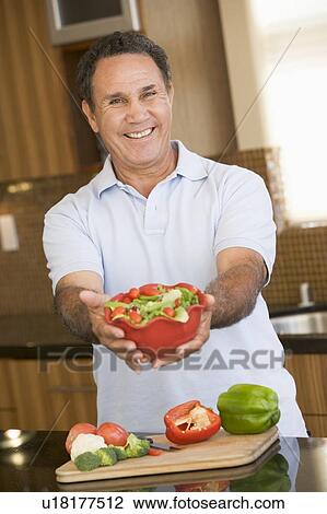 Stock Image - Man Presenting Salad. Fotosearch