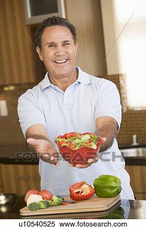 Stock Photography - Man Presenting Salad. Fotosearch