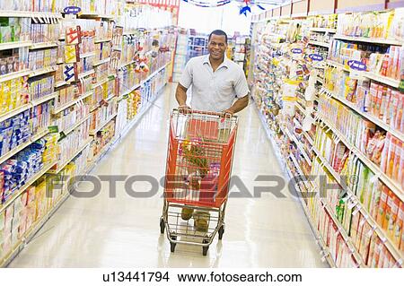 Man shopping at a grocery store View Large Photo Image Picture - Man shopping at a grocery store. Fotosearch