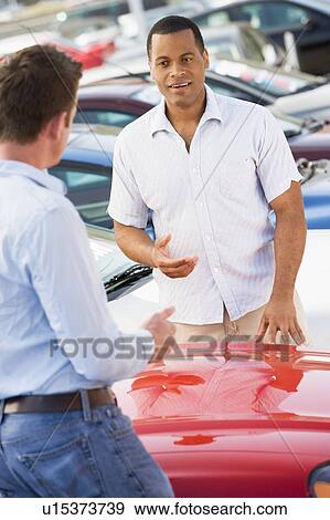 Stock Photo - Man shopping for a new car. Fotosearch