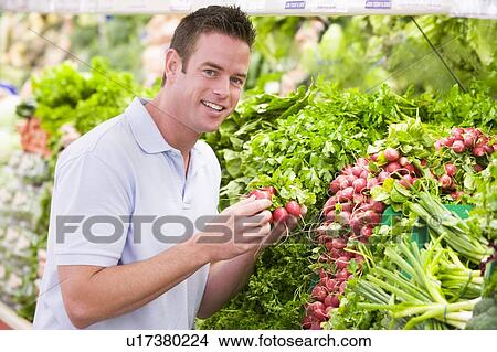 Man shopping for beets at a grocery store View Large Photo Image Picture - Man shopping for beets at a grocery store. Fotosearch