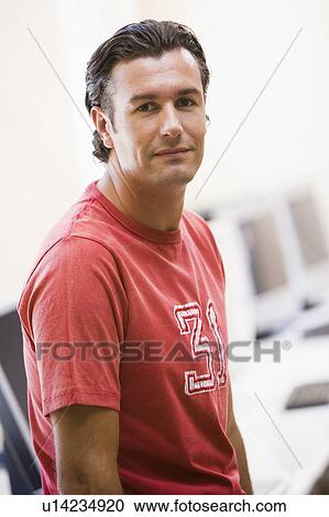Man standing in computer room View Large Photo Image Stock Image - Man standing in computer room. Fotosearch