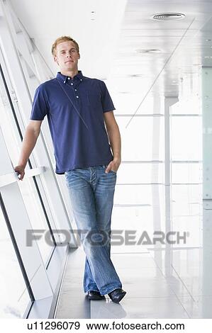 Man standing in corridor View Large Photo Image Stock Photo - Man standing in corridor. Fotosearch
