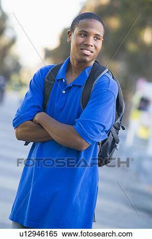 Stock Photography - Man standing outdoors looking at something (selective focus). Fotosearch