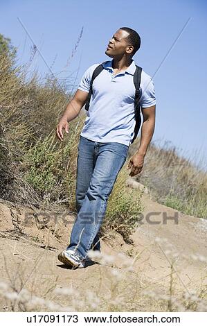 Man walking on path to beach View Large Photo Image Stock Image - Man walking on path to beach. Fotosearch