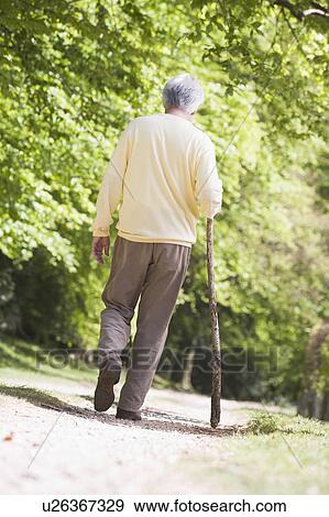 Man walking outdoors View Large Photo Image Stock Photo - Man walking outdoors. Fotosearch