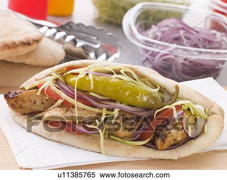 Marinated Chicken Kebab In A Pitta Bread With Salad And A Pickled Chilli View Large Photo Image Stock Photography - Marinated Chicken Kebab In A Pitta Bread With Salad And A Pickled Chilli. Fotosearch