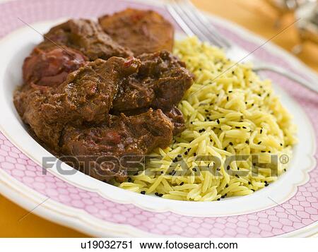 Stock Image - Meat Vindaloo with Pilau Rice. Fotosearch