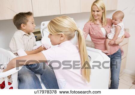 Mother And Children Doing Laundry View Large Photo Image Stock Photo - Mother And Children Doing Laundry . Fotosearch