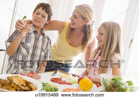Mother And Children Prepare A meal, mealtime Together View Large Photo Image Stock Photo - Mother And Children Prepare A meal, mealtime Together . Fotosearch