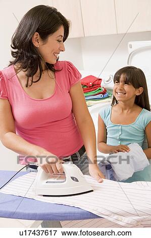 Stock Photo - Mother And Daughter Ironing . Fotosearch