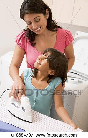 Stock Photo - Mother And Daughter Ironing . Fotosearch