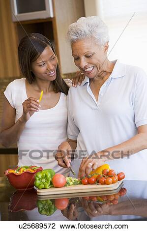 Mother And Daughter Preparing A meal, mealtime Together View Large Photo Image Stock Image - Mother And Daughter Preparing A meal, mealtime Together. Fotosearch
