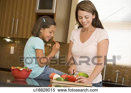 Mother And Daughter Preparing meal, mealtime Together View Large Photo Image Stock Photography - Mother And Daughter Preparing meal, mealtime Together . Fotosearch