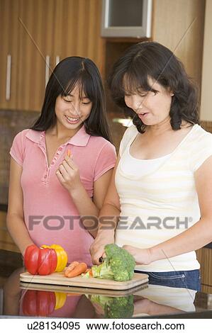Mother And Daughter Preparing meal, mealtime Together View Large Photo Image Stock Photography - Mother And Daughter Preparing meal, mealtime Together. Fotosearch