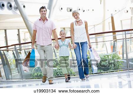 Mother and father with young daughter at a shopping mall View Large Photo Image Picture - Mother and father with young daughter at a shopping mall. Fotosearch