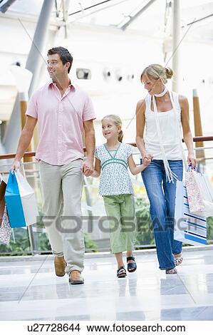Picture - Mother and father with young daughter at a shopping mall. Fotosearch